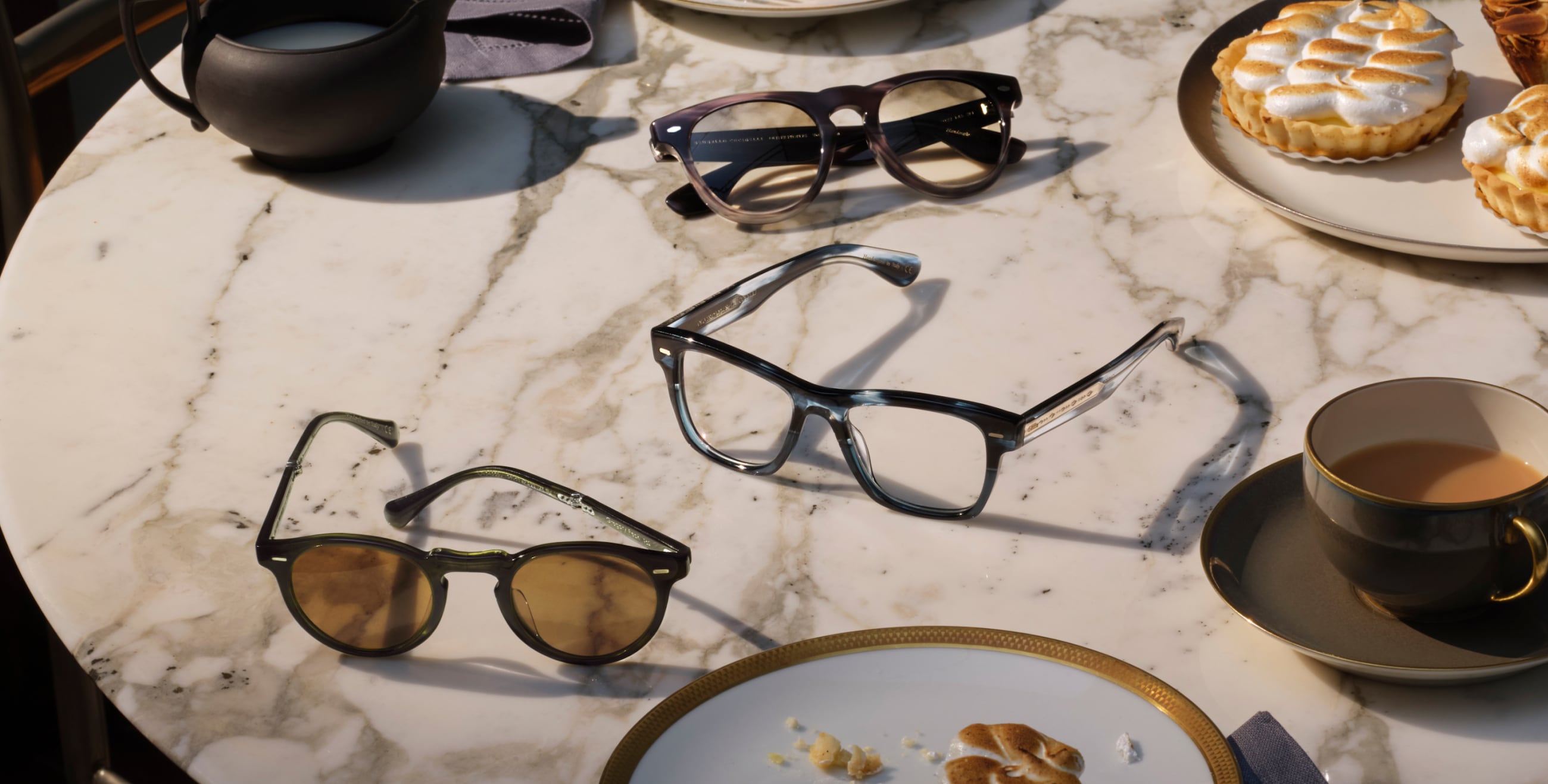 An array of frames with nuanced ornamentation, like G.Ponti-1, Nino Sun, Gregory Peck 1962., Hollins, and Oliver, accompany delectable desserts and late night conversations.