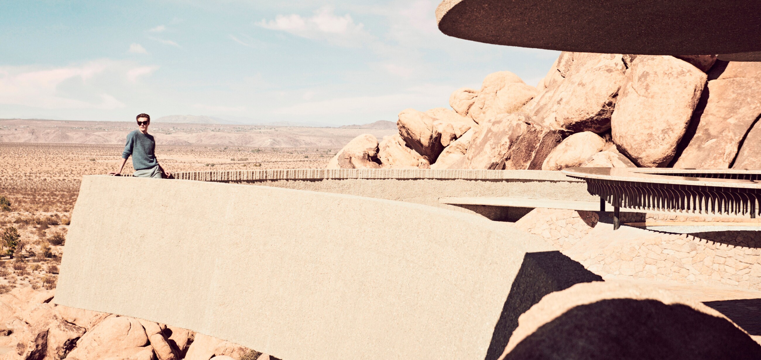 Lucky Blue looks out over Joshua Tree from the layered balcony of the home.
